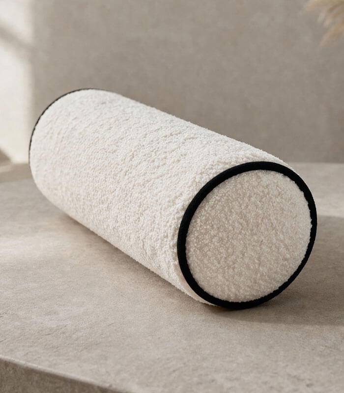 Boucle fabric bolster cushion with contrast piping