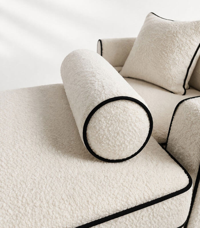 Boucle fabric bolster cushion with contrast piping