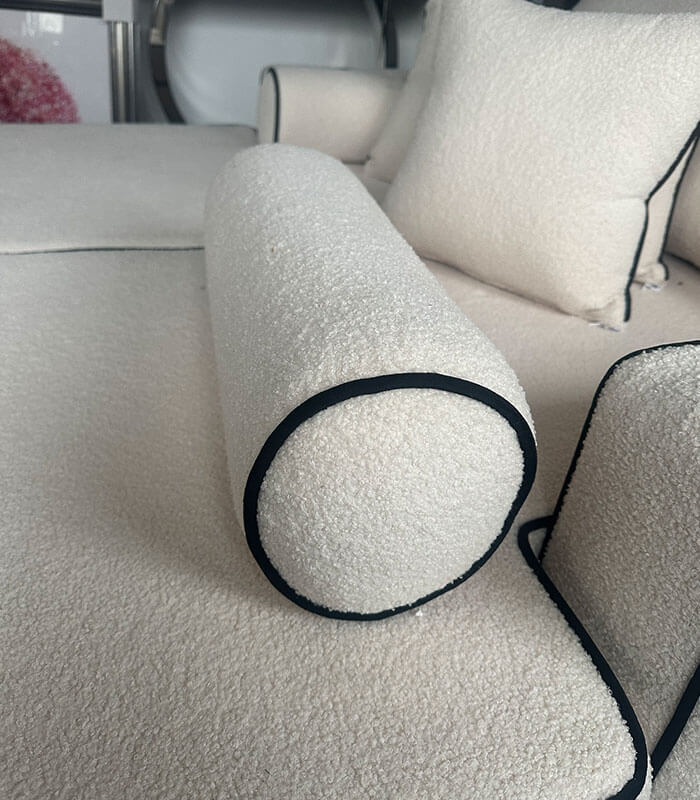 Boucle fabric bolster cushion with contrast piping