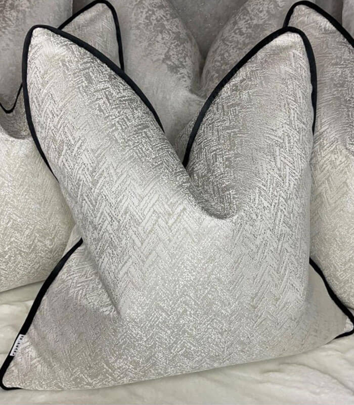 Luxury ivory shimmer cushion with black piping