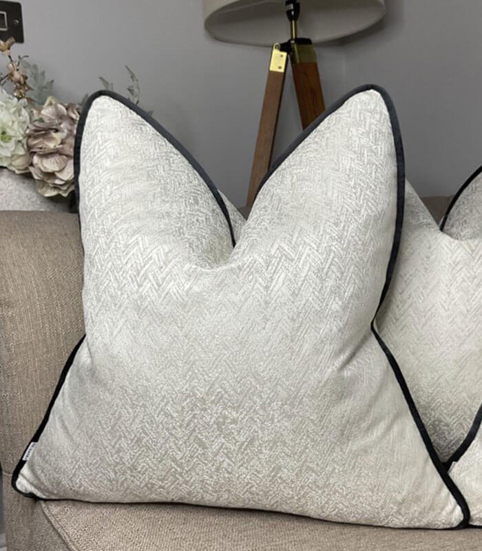 Luxury ivory shimmer cushion with black piping