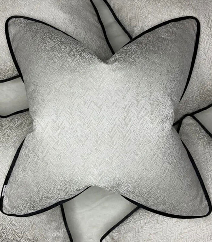 Luxury ivory shimmer cushion with black piping